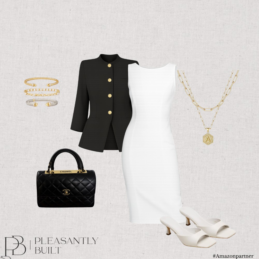 Black tailored jacket layered over a white dress with black and gold accessories
